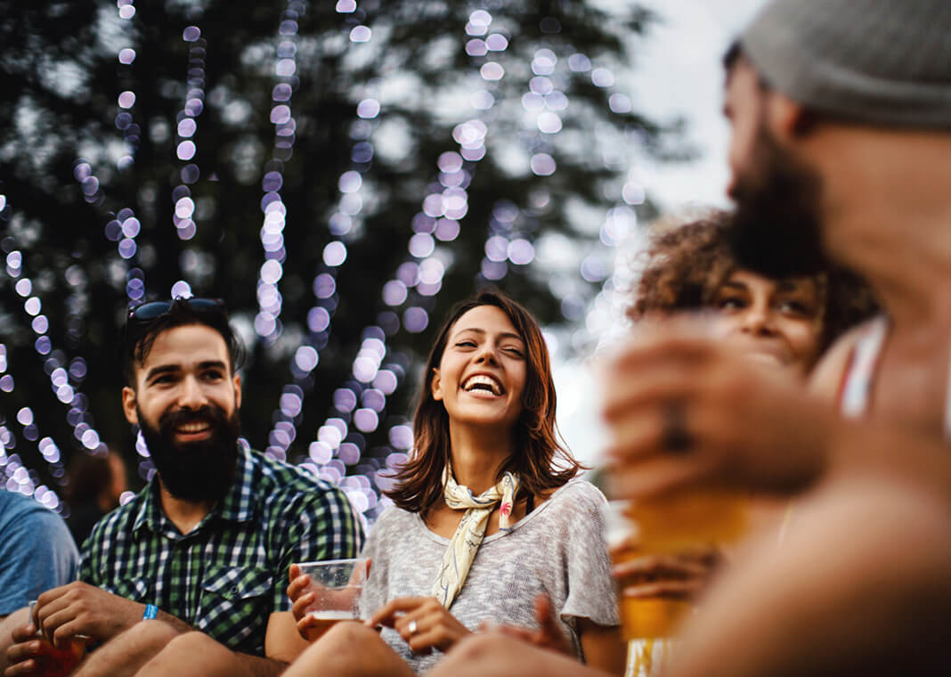 joyful adults sitting outside - Aja Koska/E+/Getty Images