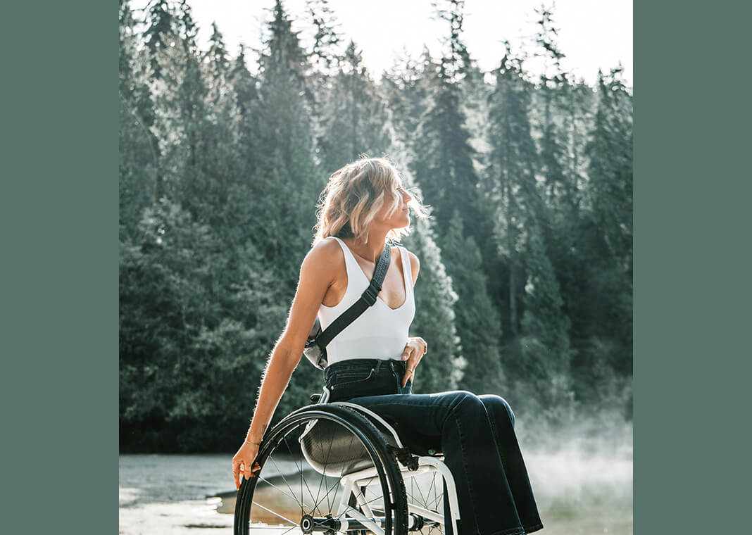 woman in wheelchair soaking in nature - photo by Zachary Kyra-Derksen on Unsplash