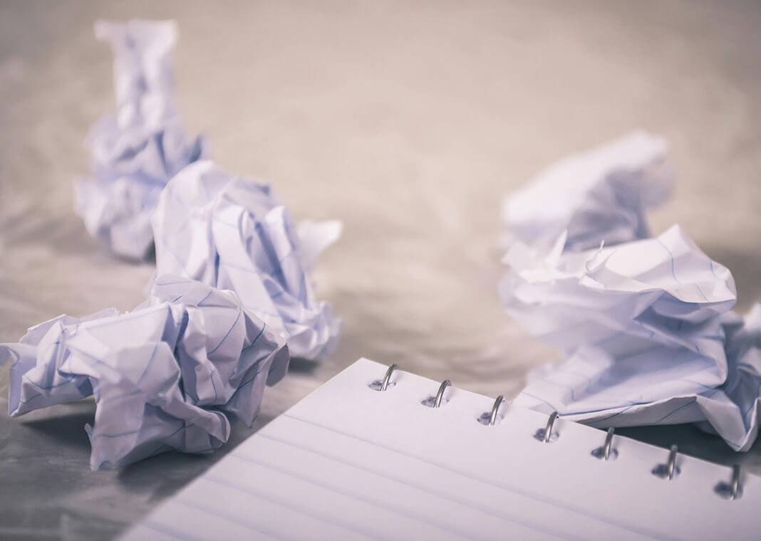 crumpled paper next to notepad - photo by Steve Johnson on Pexels