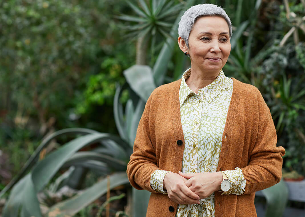 older woman in brown cardigan smiling at off-screen friend - photo by Marcus Aurelius on Pexels