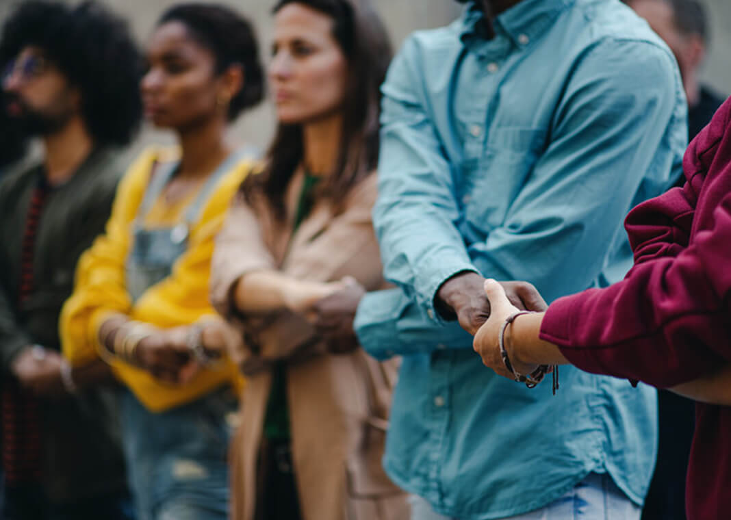 line of people standing in solidarity for social justice - Halfpoint/Shutterstock.com