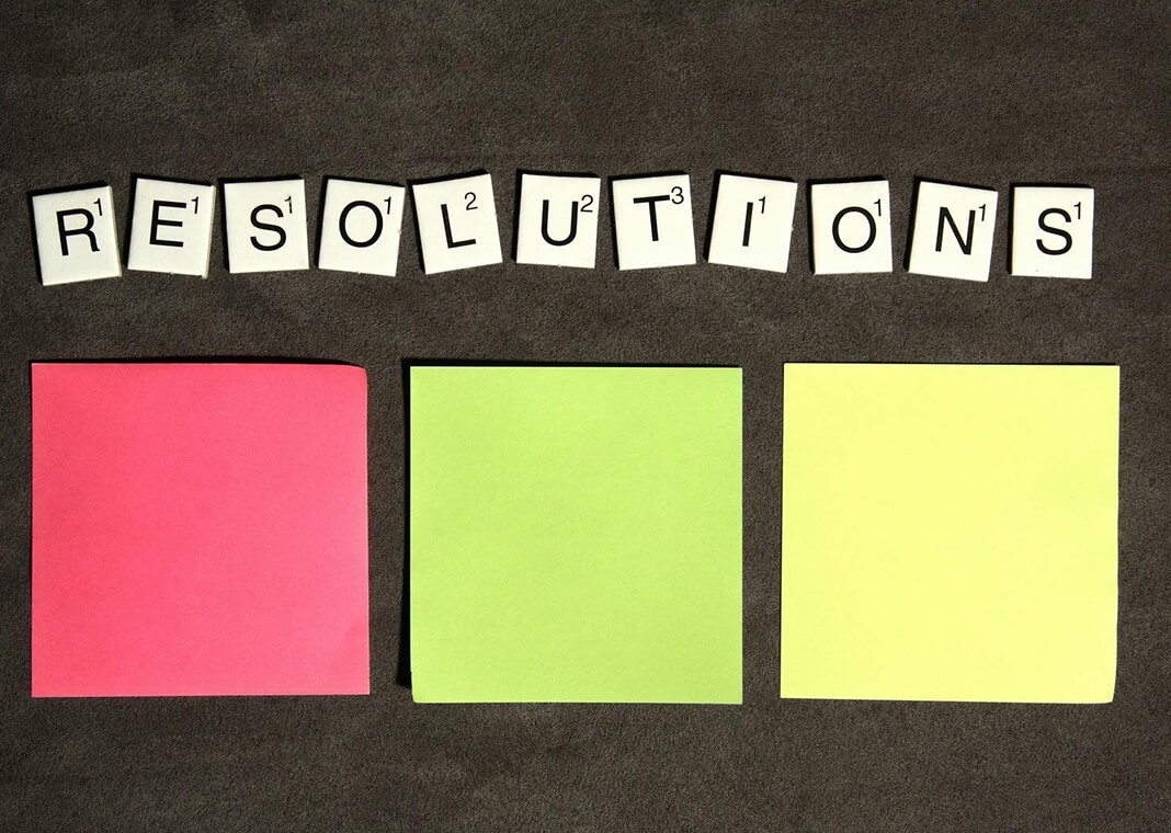 Resolutions - word spelled out in tiles above three sticky notes - photo by Breakingpic on Pexels